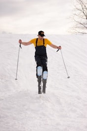 a man riding skis down a snow covered slope