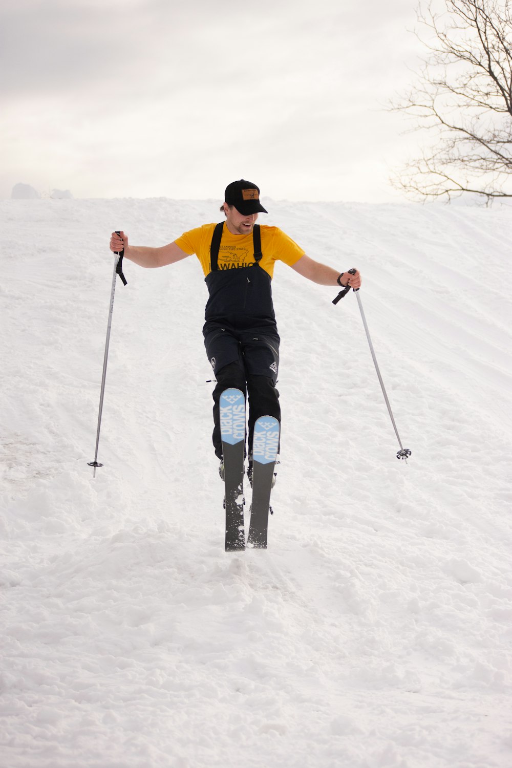 a man riding skis down a snow covered slope