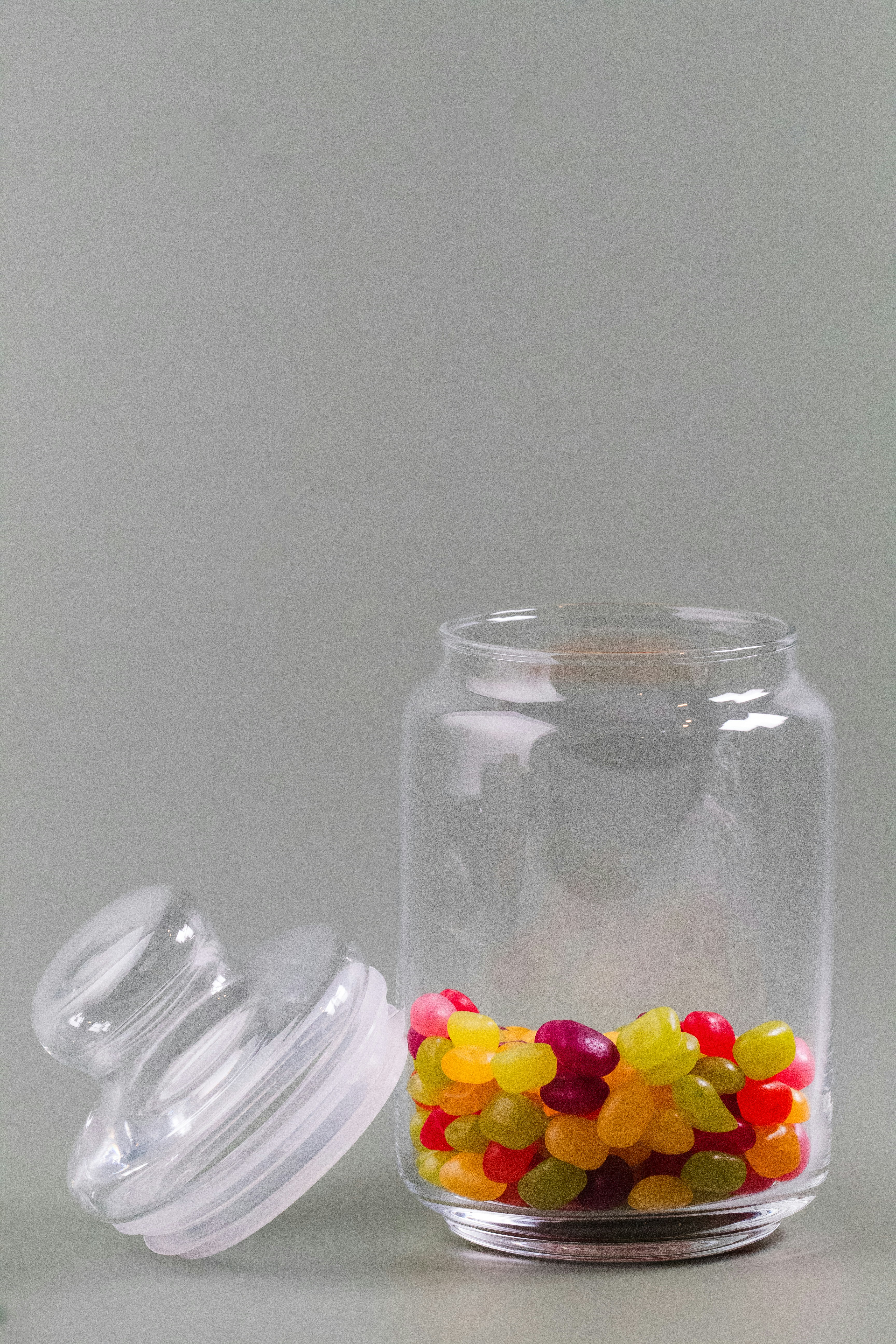 a glass jar with gummy bears inside of it