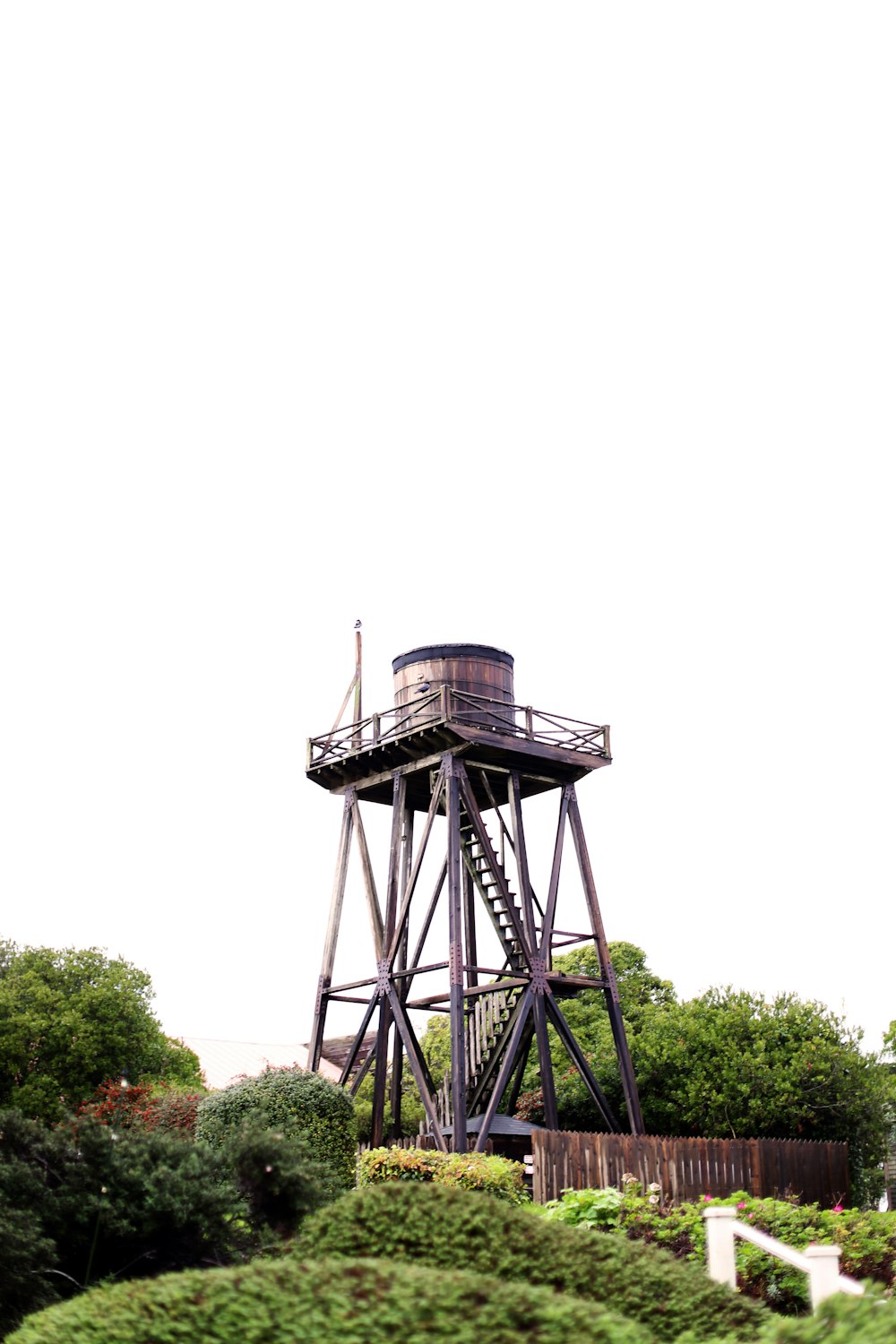 a tall tower sitting on top of a lush green hillside