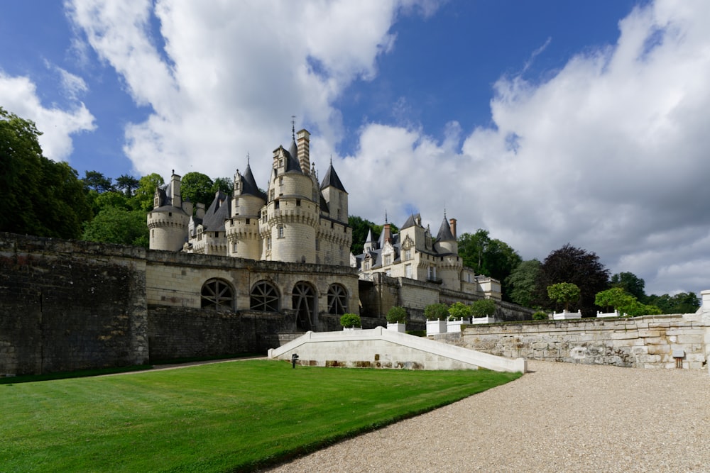 a castle with a large lawn in front of it