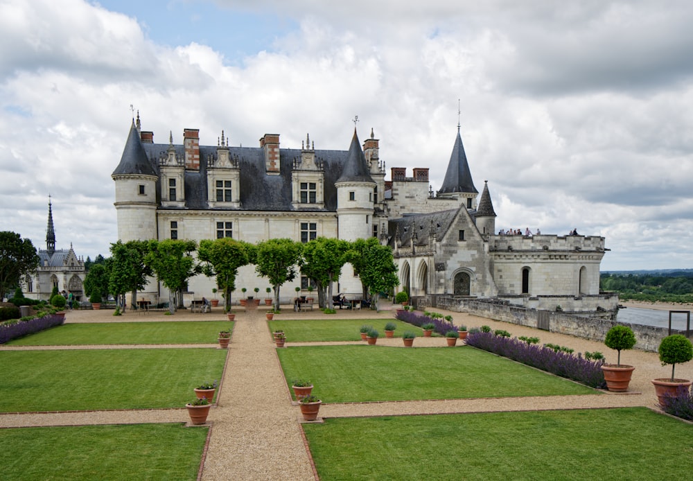 a large castle with a garden in front of it