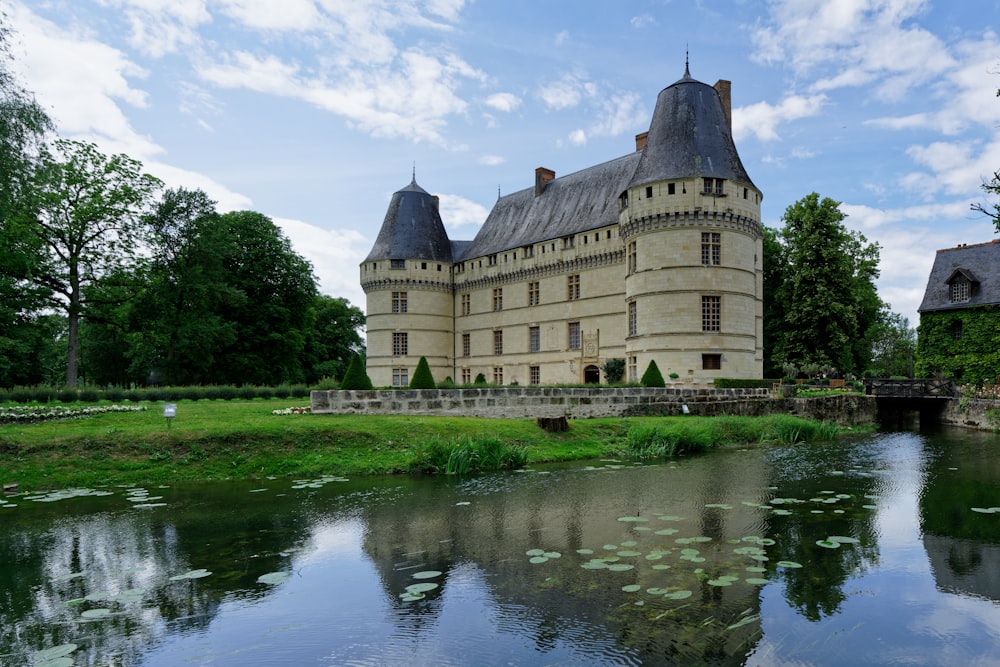 a castle with a pond in front of it