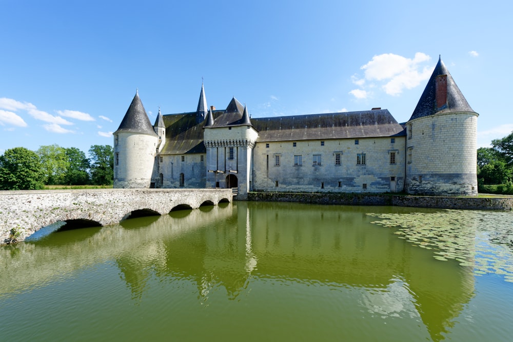 a large castle with a bridge over a body of water