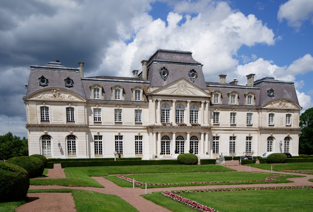 a large building with a garden in front of it