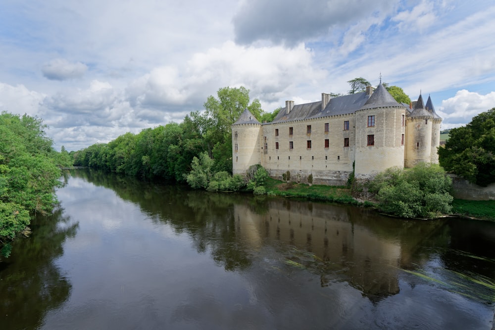 a large building sitting on the side of a river