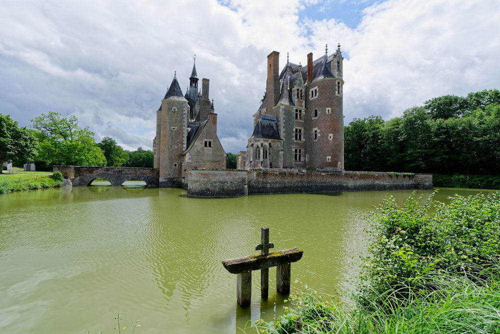 a large castle sitting on top of a lush green field