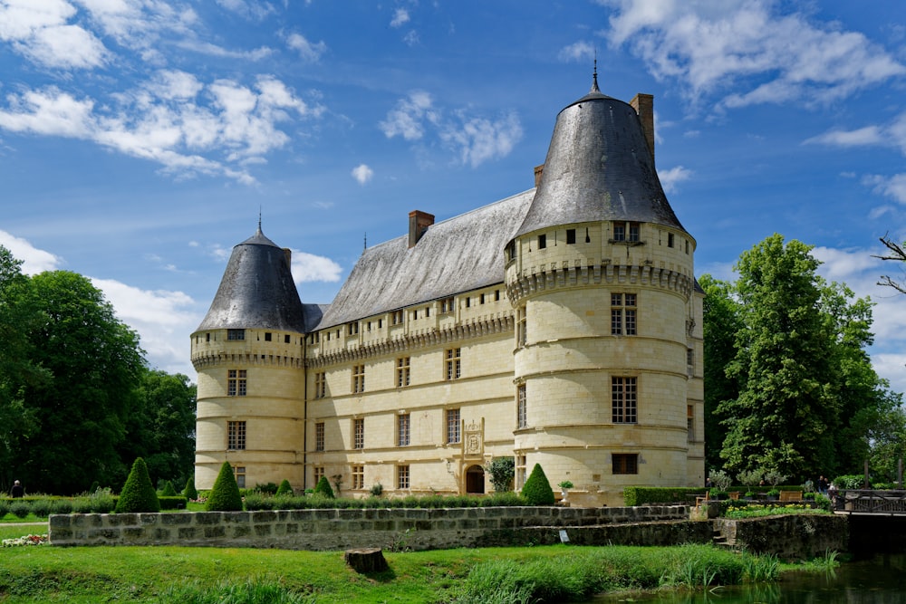 a large castle like building sitting next to a river