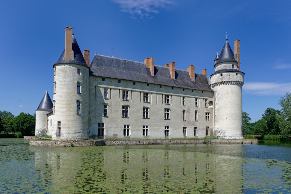 a castle with a pond in front of it
