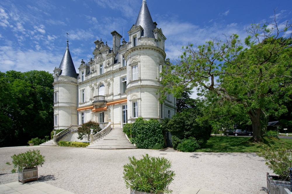 a large castle like building with a lot of trees around it