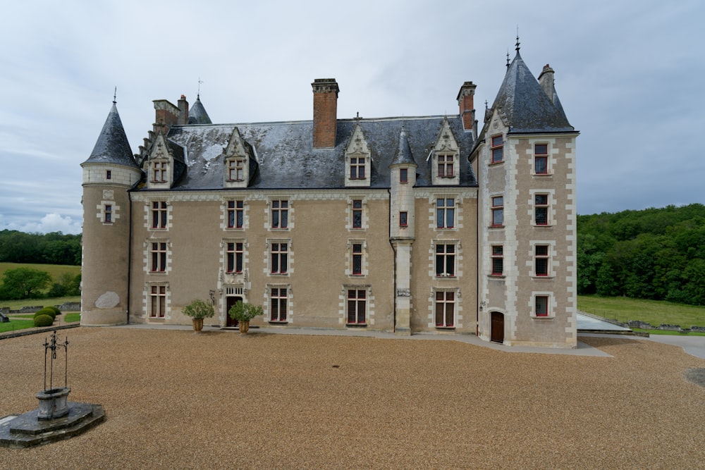 a large castle like building with a fountain in front of it