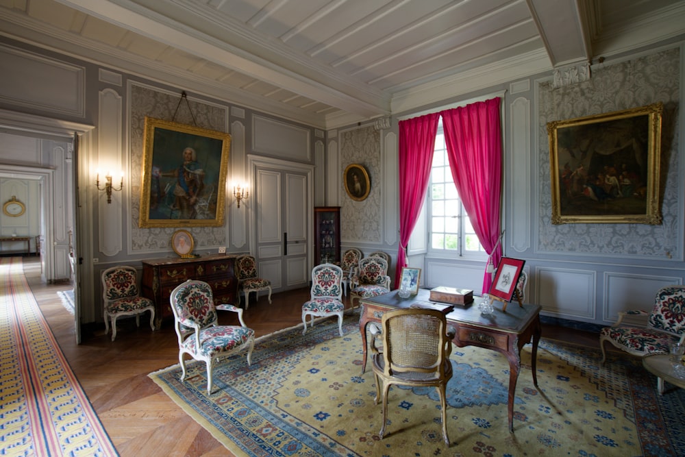 a room with a lot of chairs and paintings on the walls