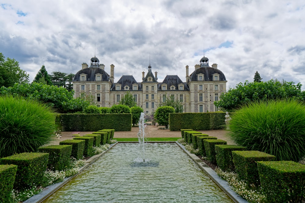 a large building with a fountain in front of it