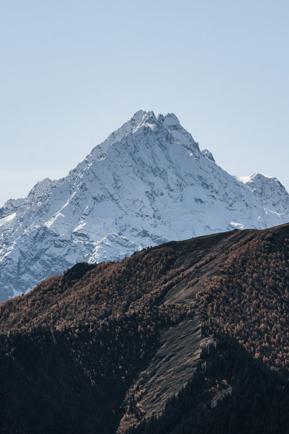 a mountain with a snow covered peak in the distance