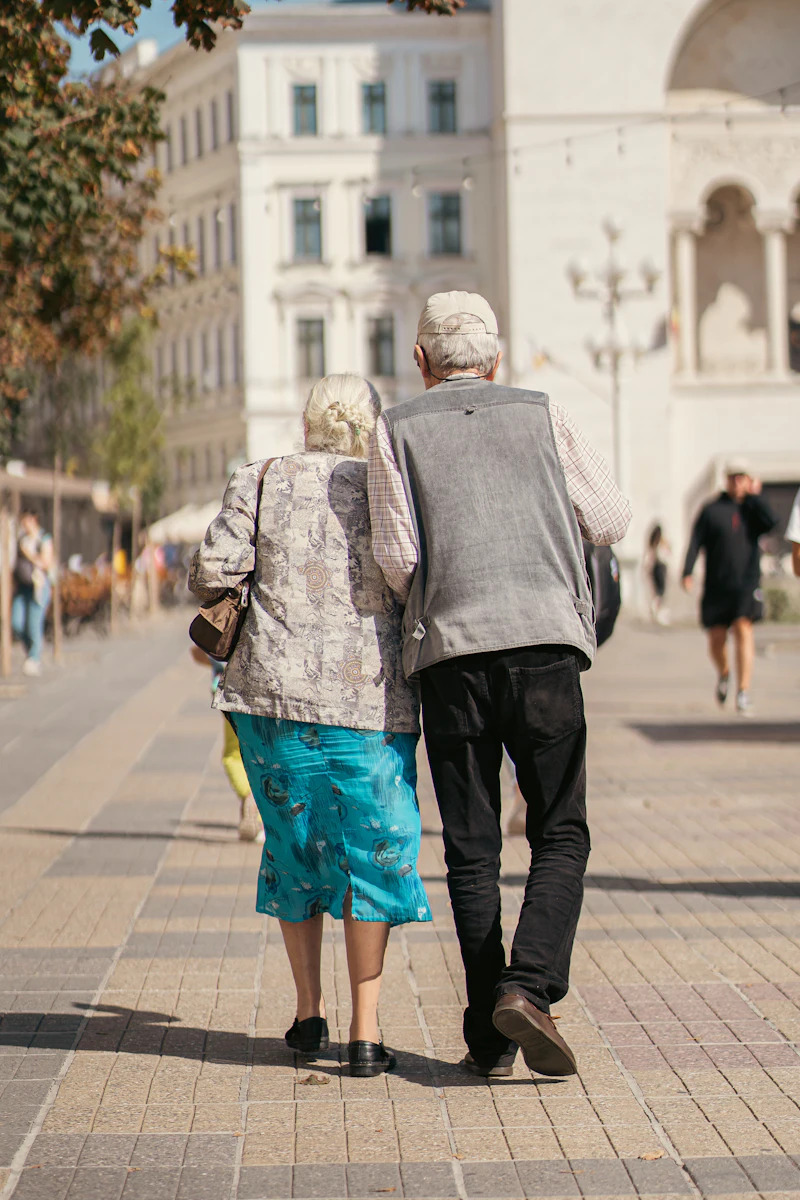 Two people walking together down a quiet street