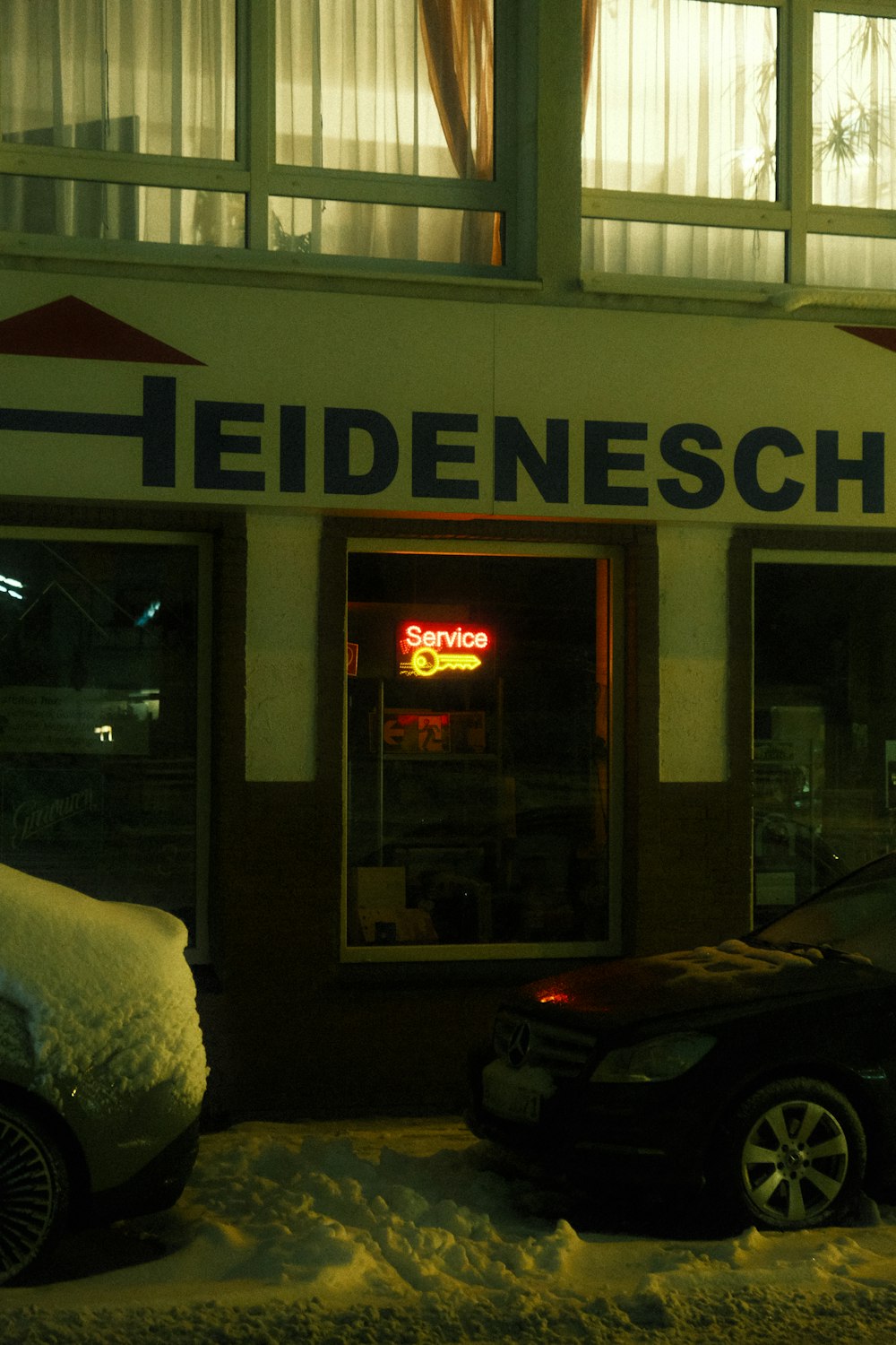 a car parked in front of a restaurant in the snow