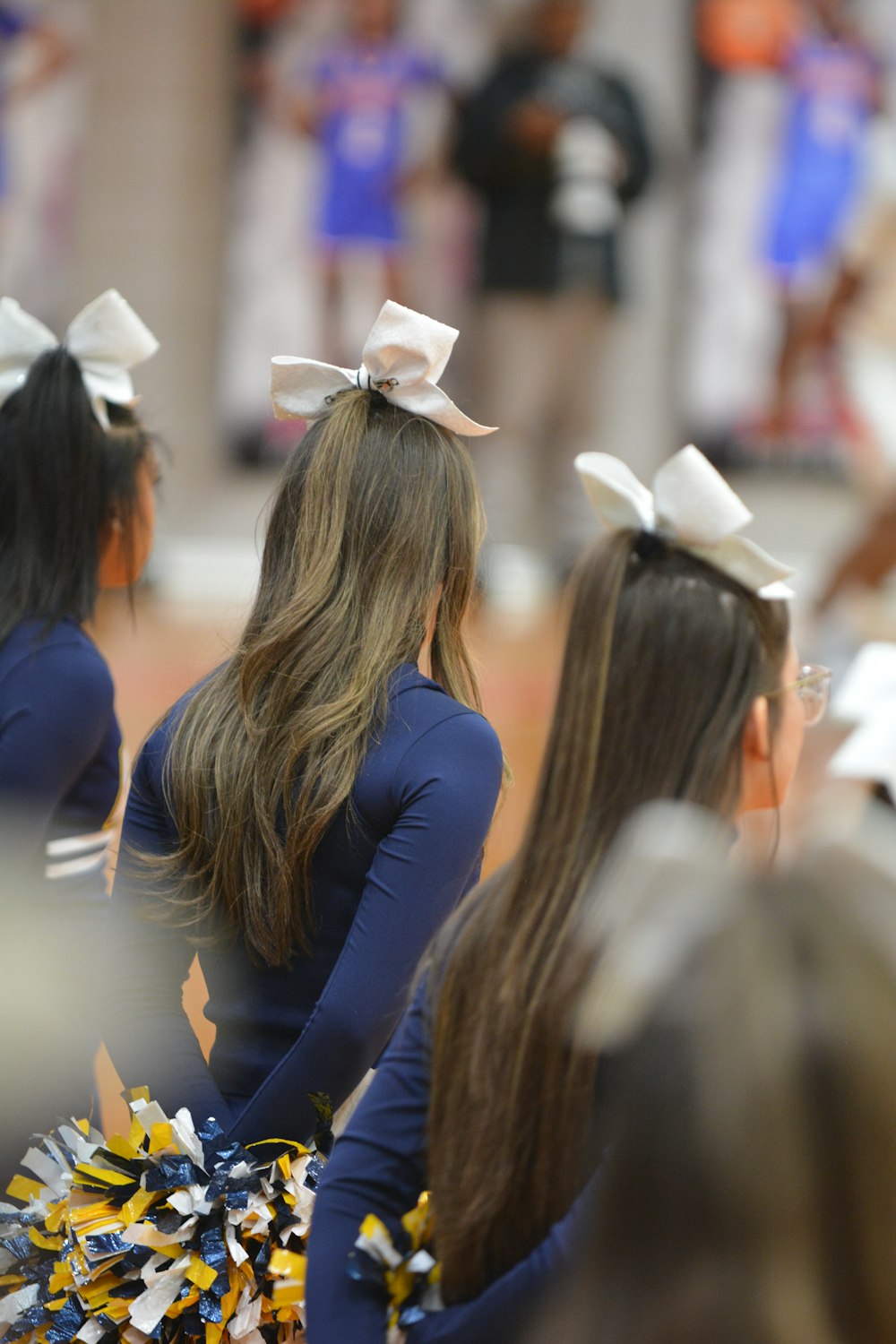 a group of cheerleaders standing next to each other
