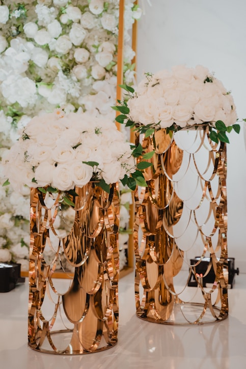 a couple of vases with flowers on top of a table