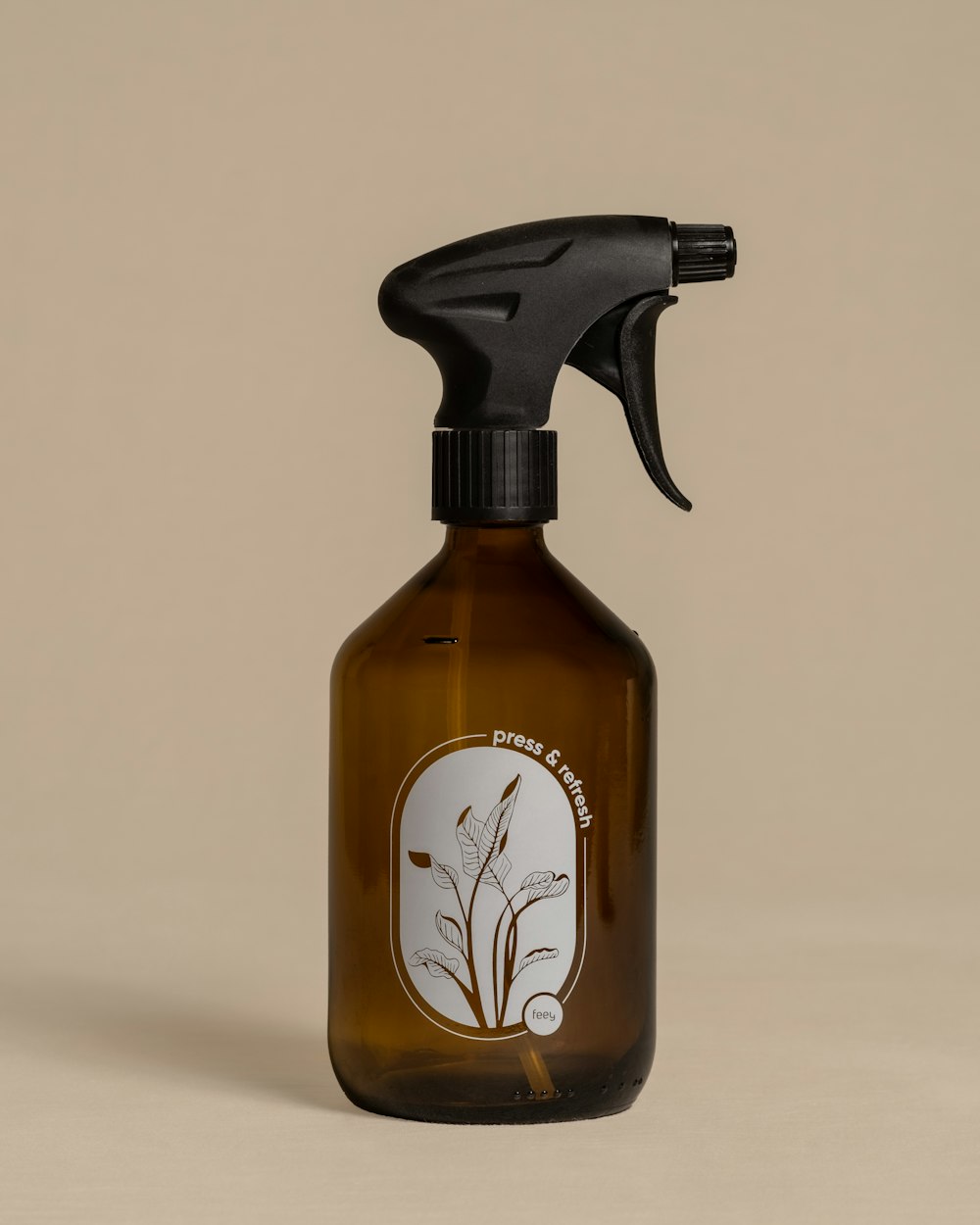 a brown glass bottle with a black sprayer on top of it