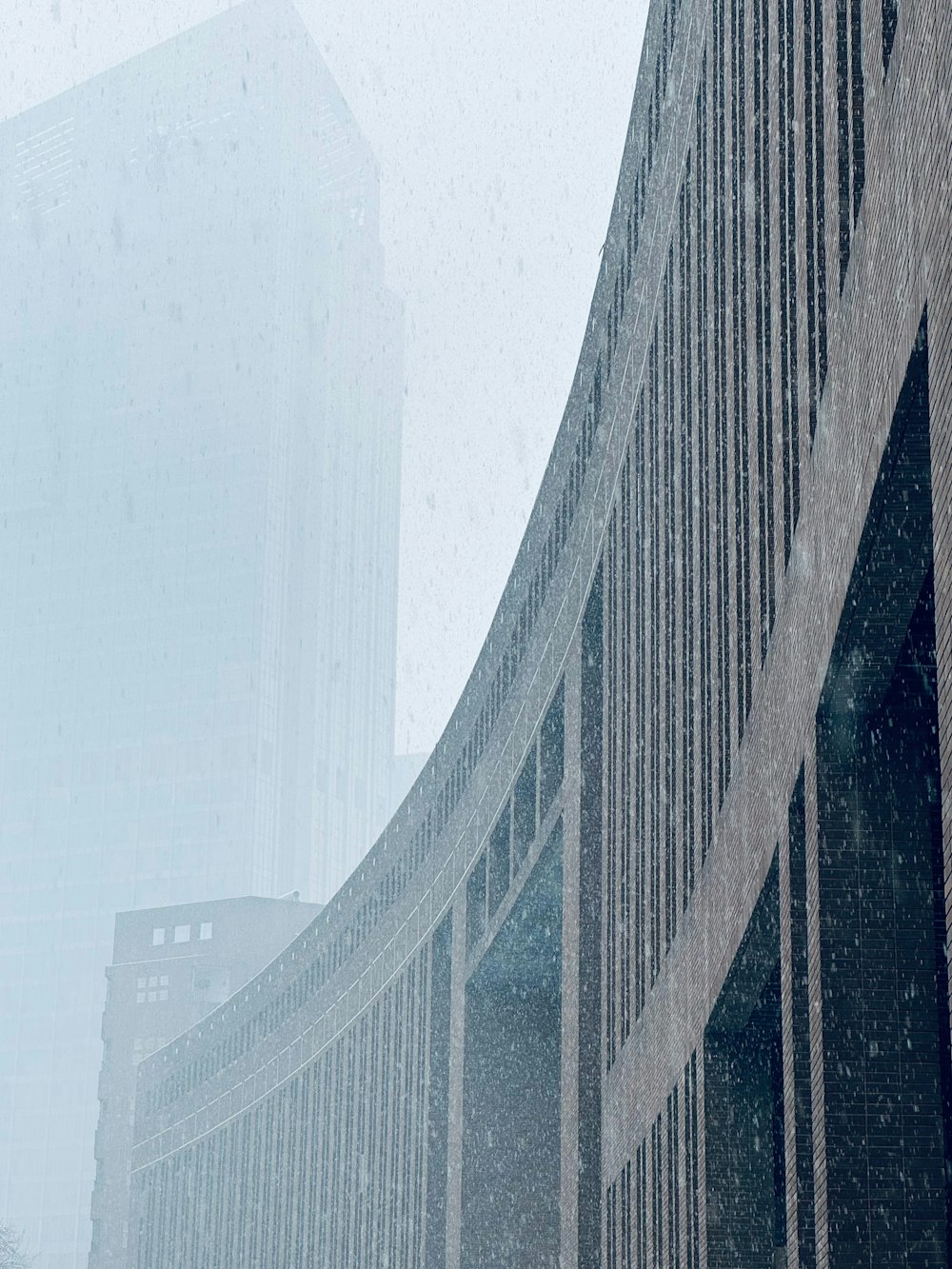 a tall building sitting next to a tall building in the snow