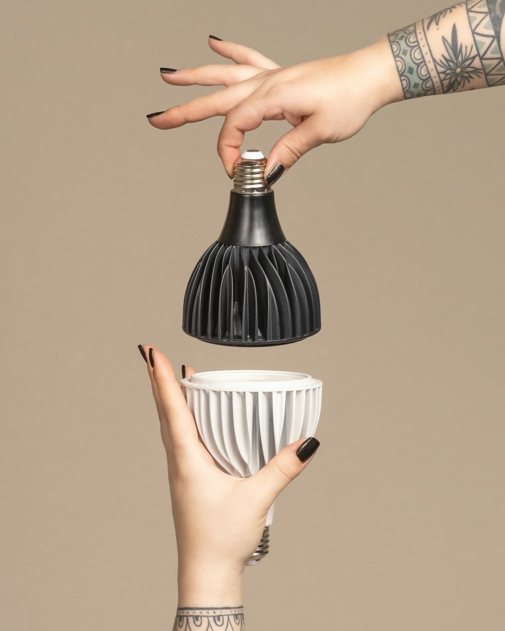 a woman's hand reaching for a light bulb