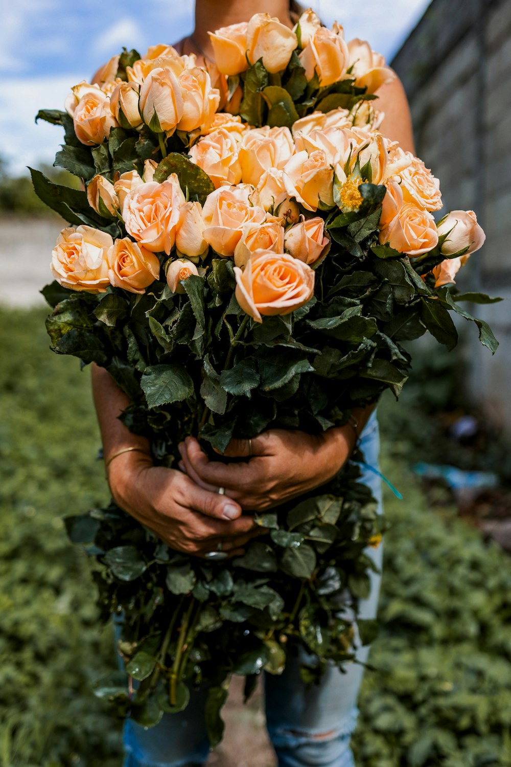 a person holding a bunch of flowers in their hands