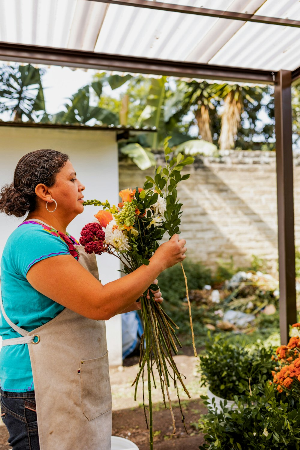 a woman holding a bunch of flowers in her hands