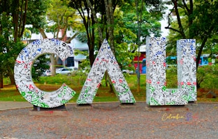 a large metal sign that is in the middle of a park