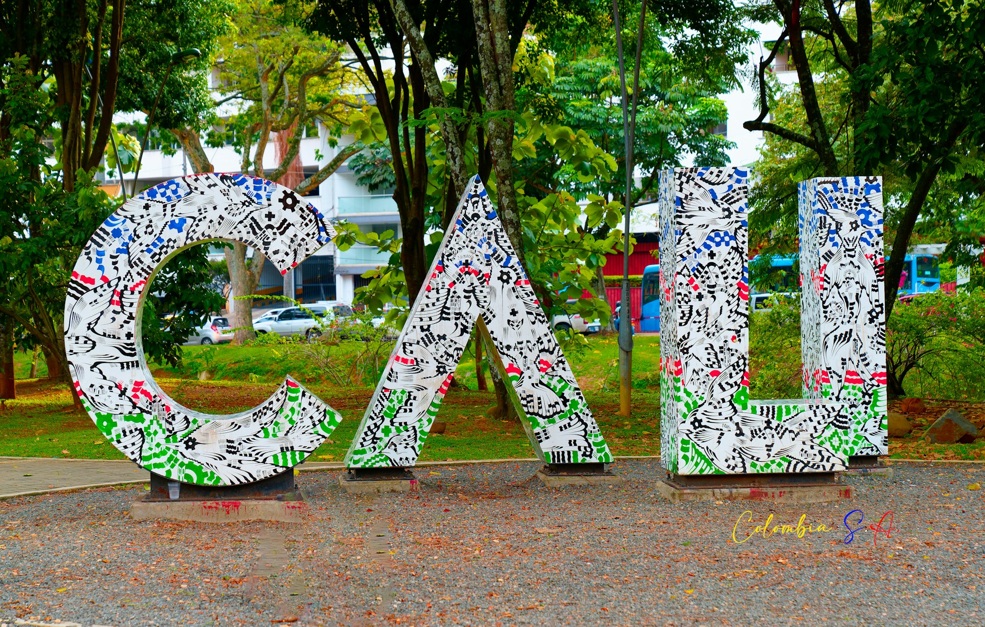 a large metal sign that is in the middle of a park
