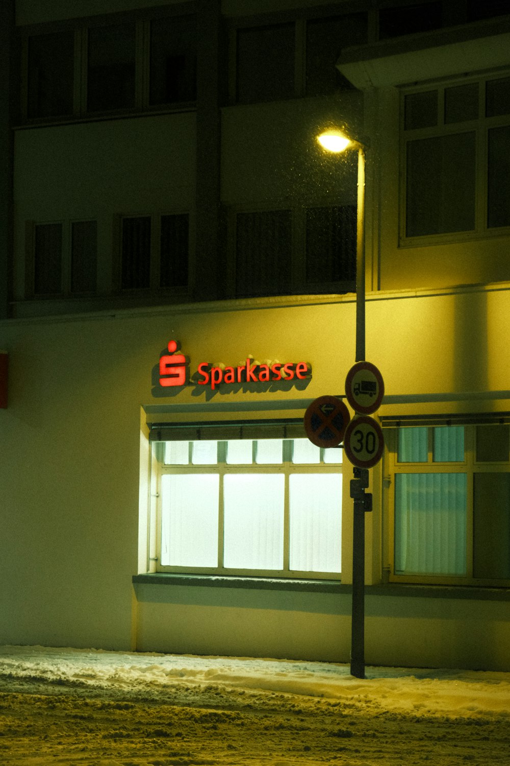 a street sign in front of a building at night