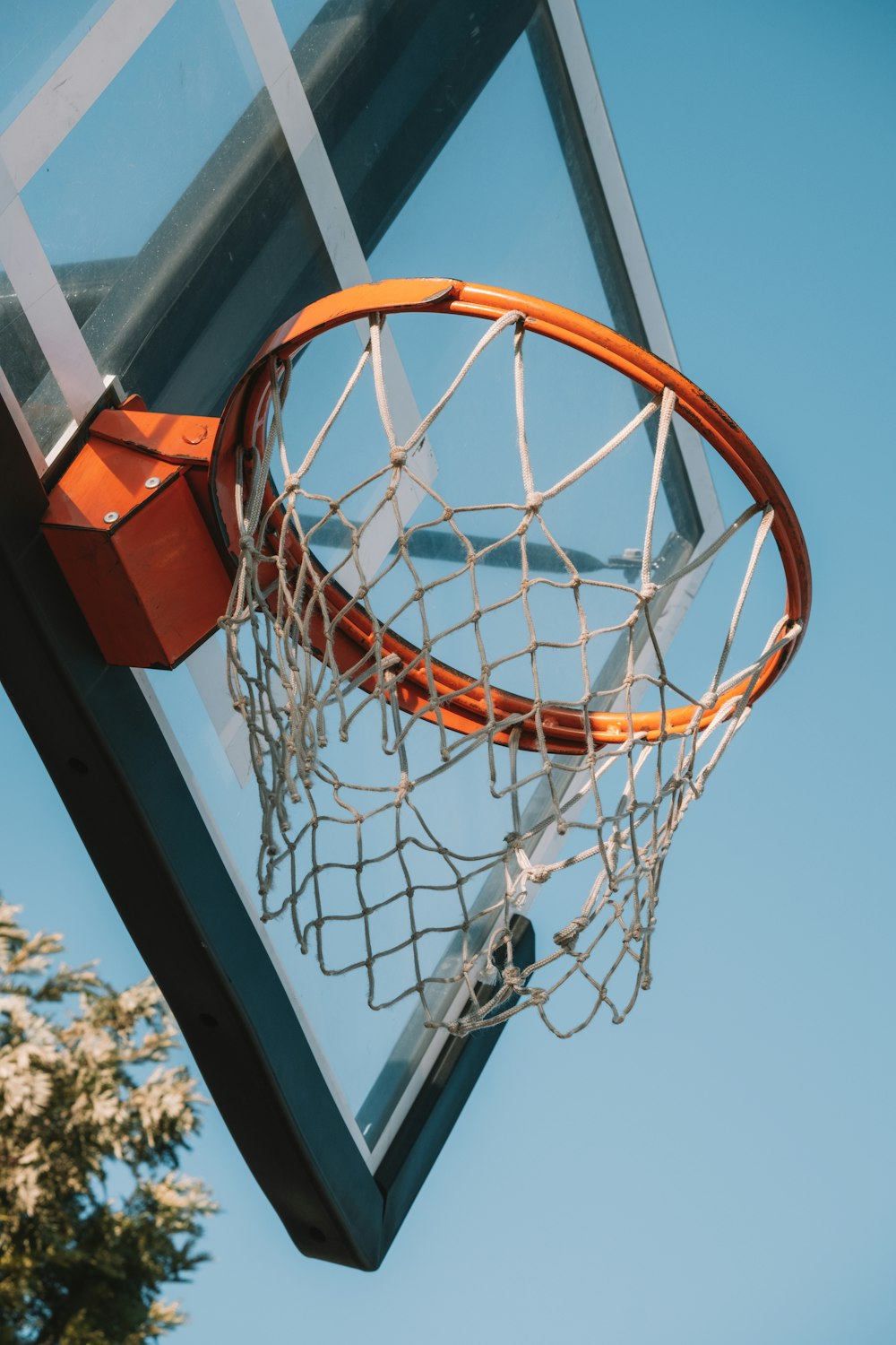 a basketball going through the net of a basketball hoop