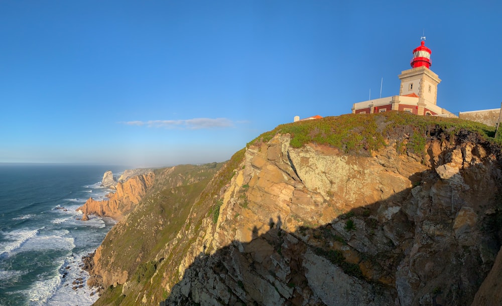 a lighthouse on a cliff overlooking the ocean