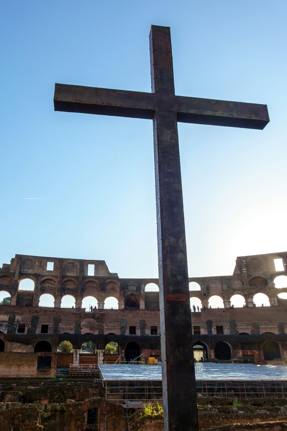 a large wooden cross in front of a building