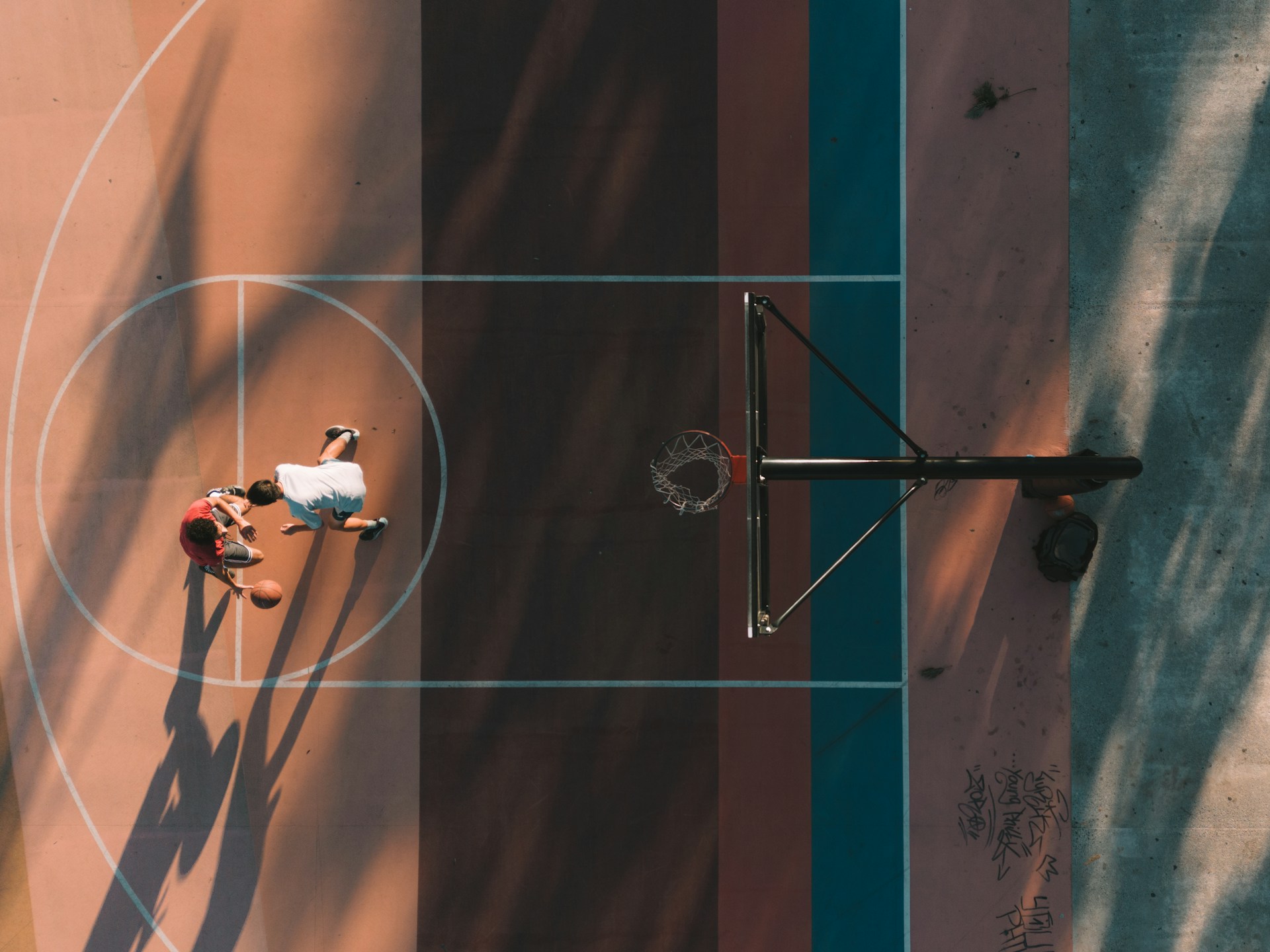 two people playing basketball on a basketball court