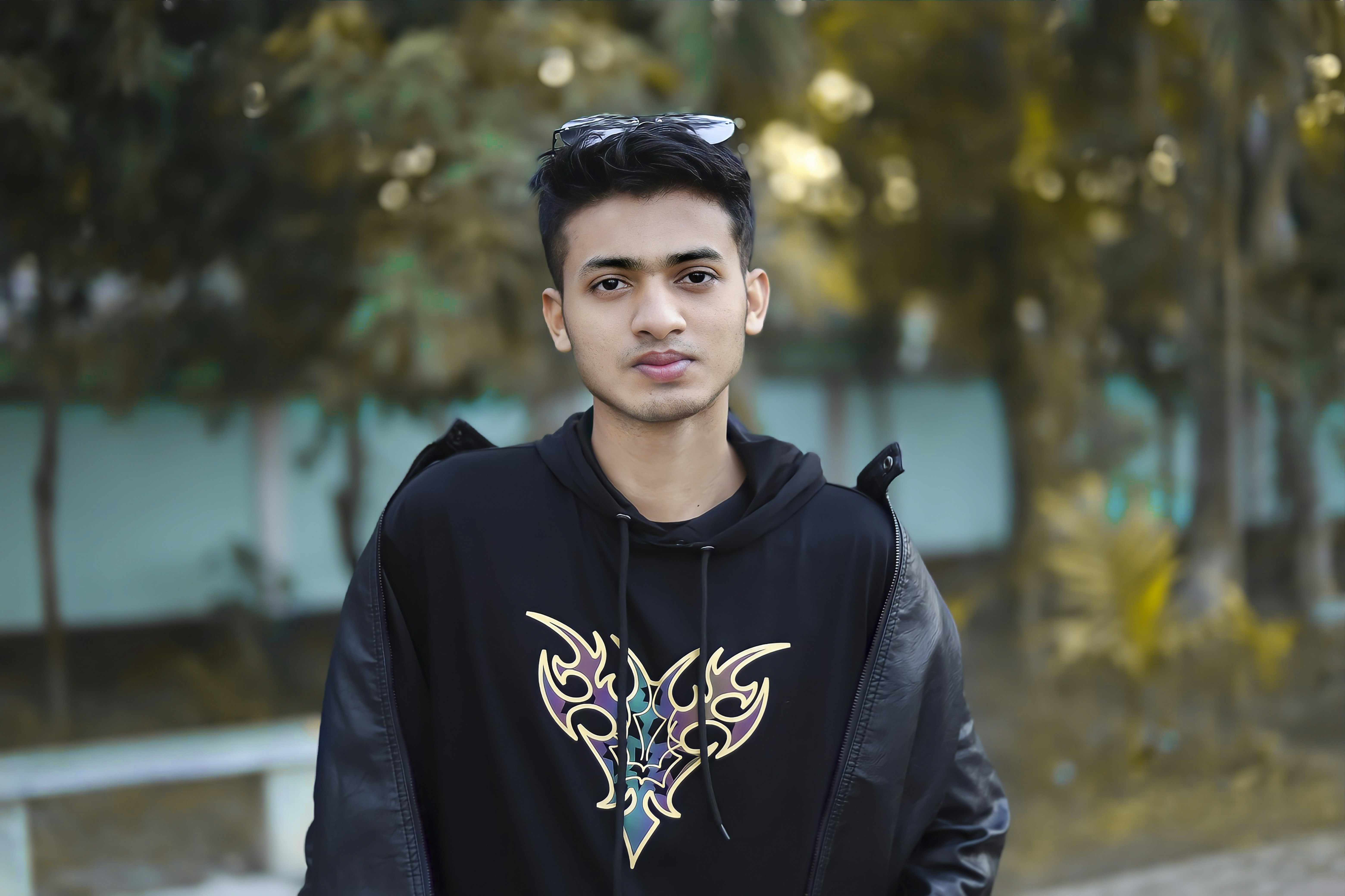 black designer hoodie styled with denim and sneakers red accents luxury streetwear