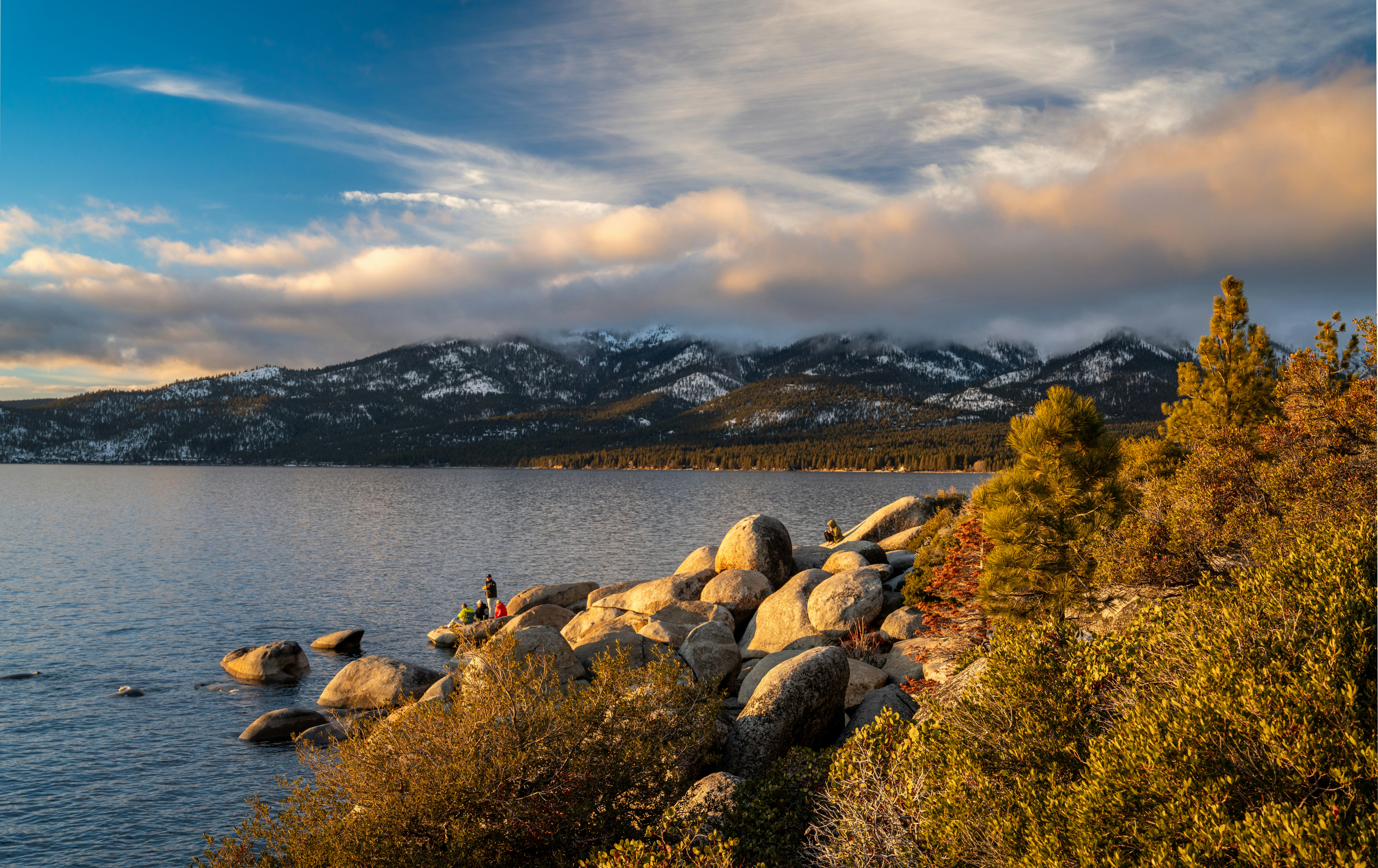 a person standing on rocks near a body of water, Sunsets are proof that no matter what happens, every day can end beautifully