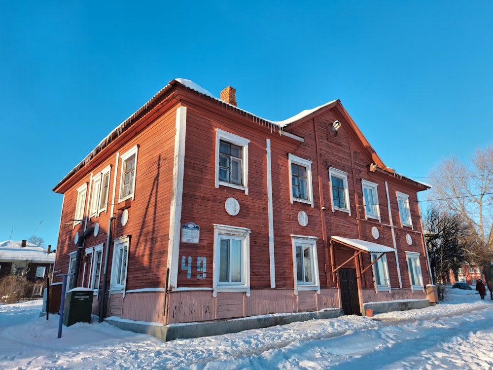 a red building with a clock on the front of it