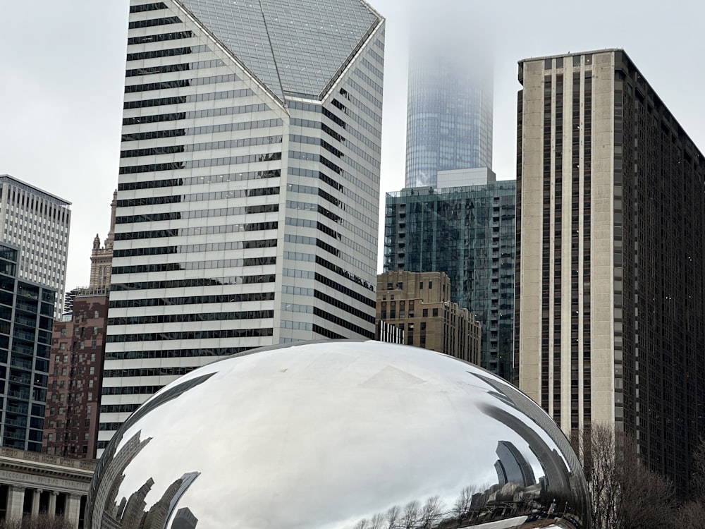 a large metal ball in the middle of a city