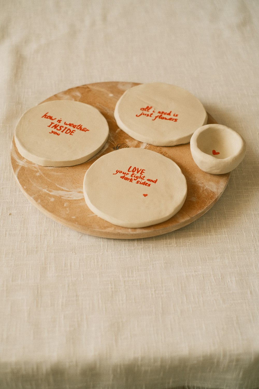 a set of four ceramic plates with writing on them
