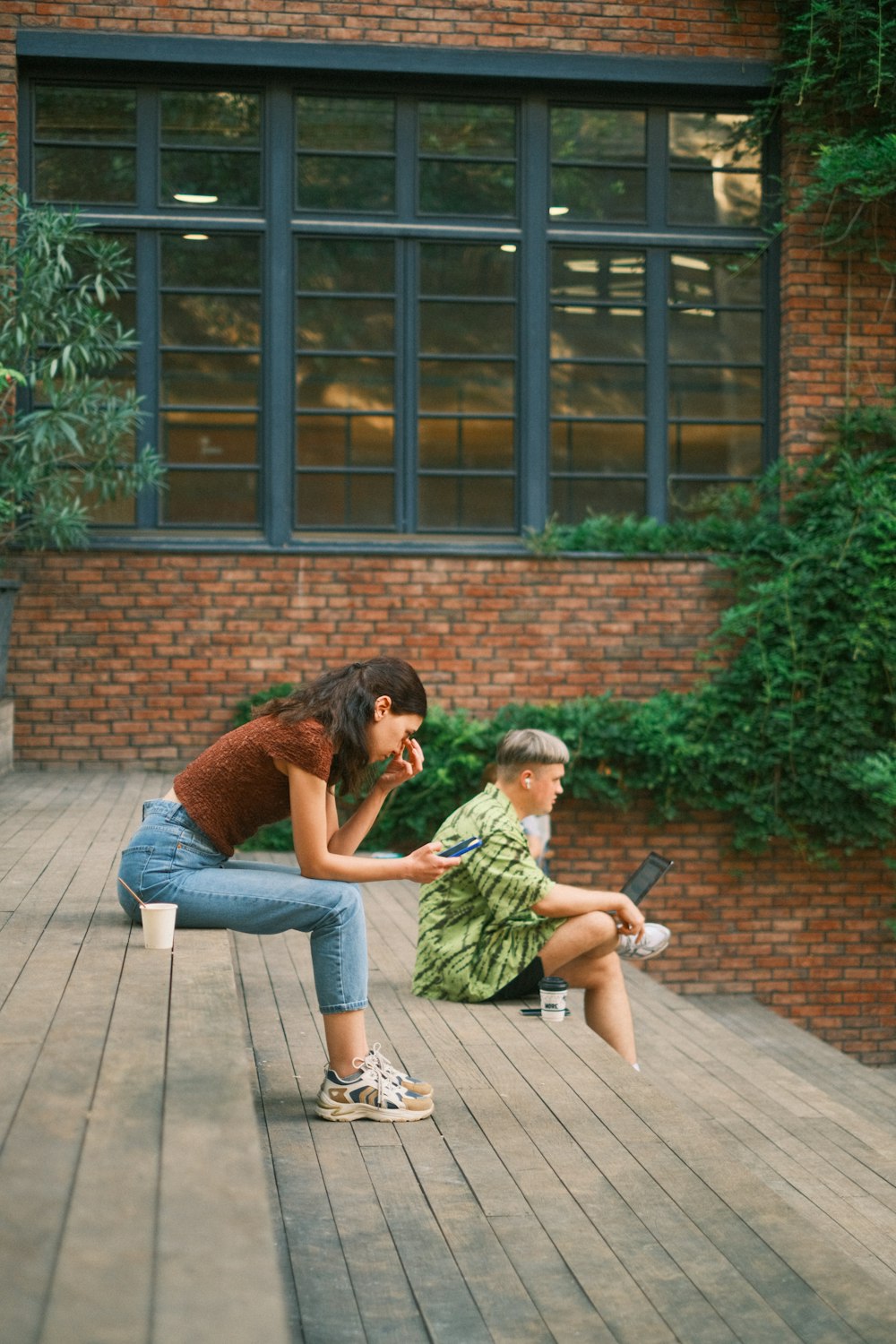 a woman sitting on a bench next to a boy