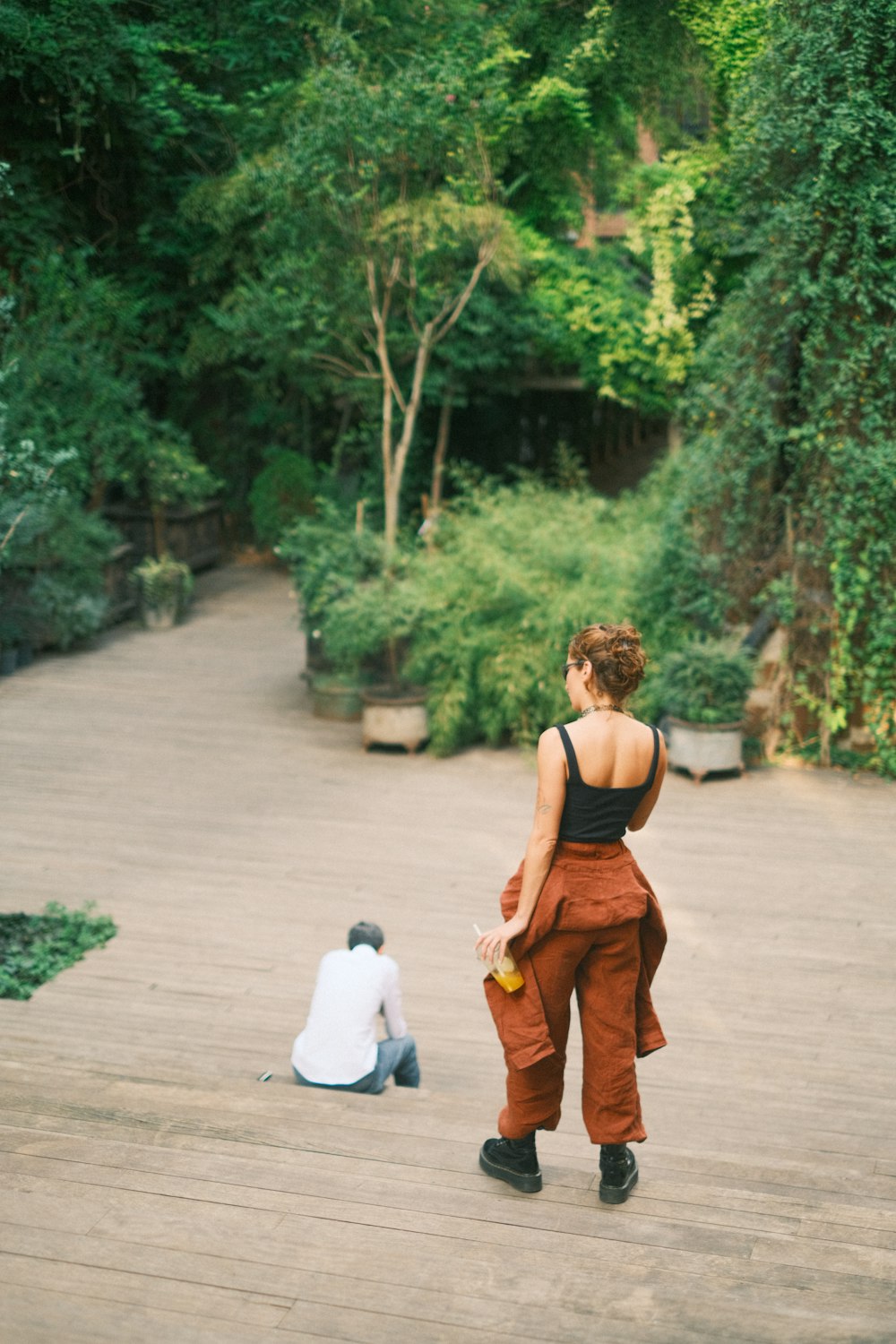 a woman in a black top and some trees