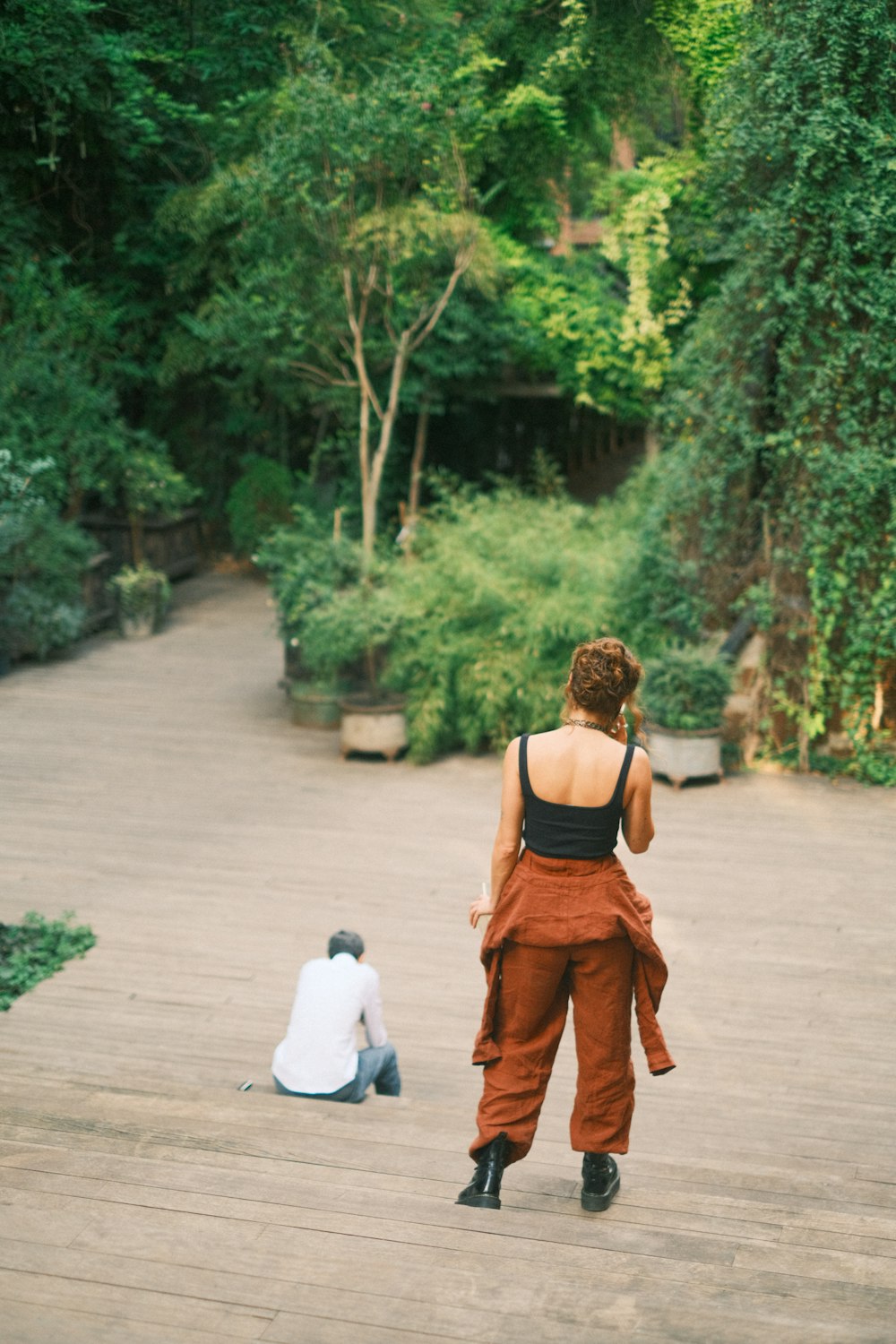 a woman standing next to a man on a wooden walkway