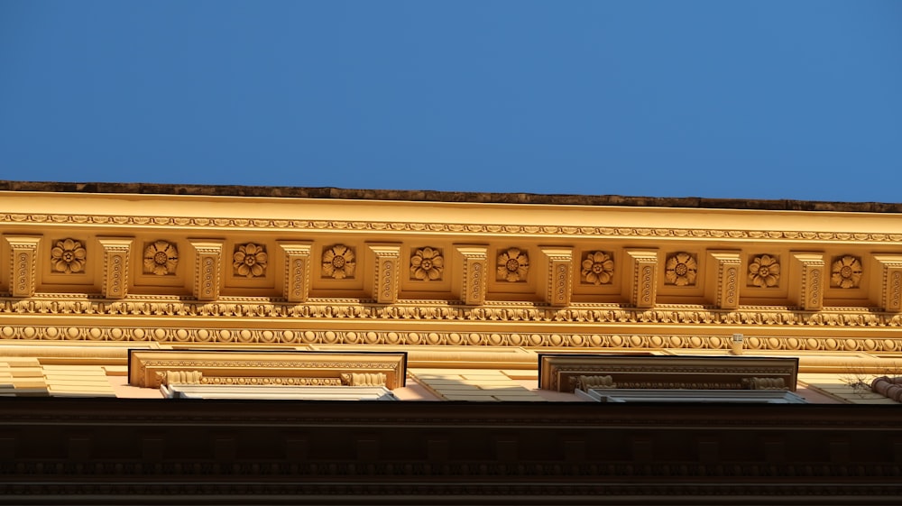 the top of a building with a blue sky in the background