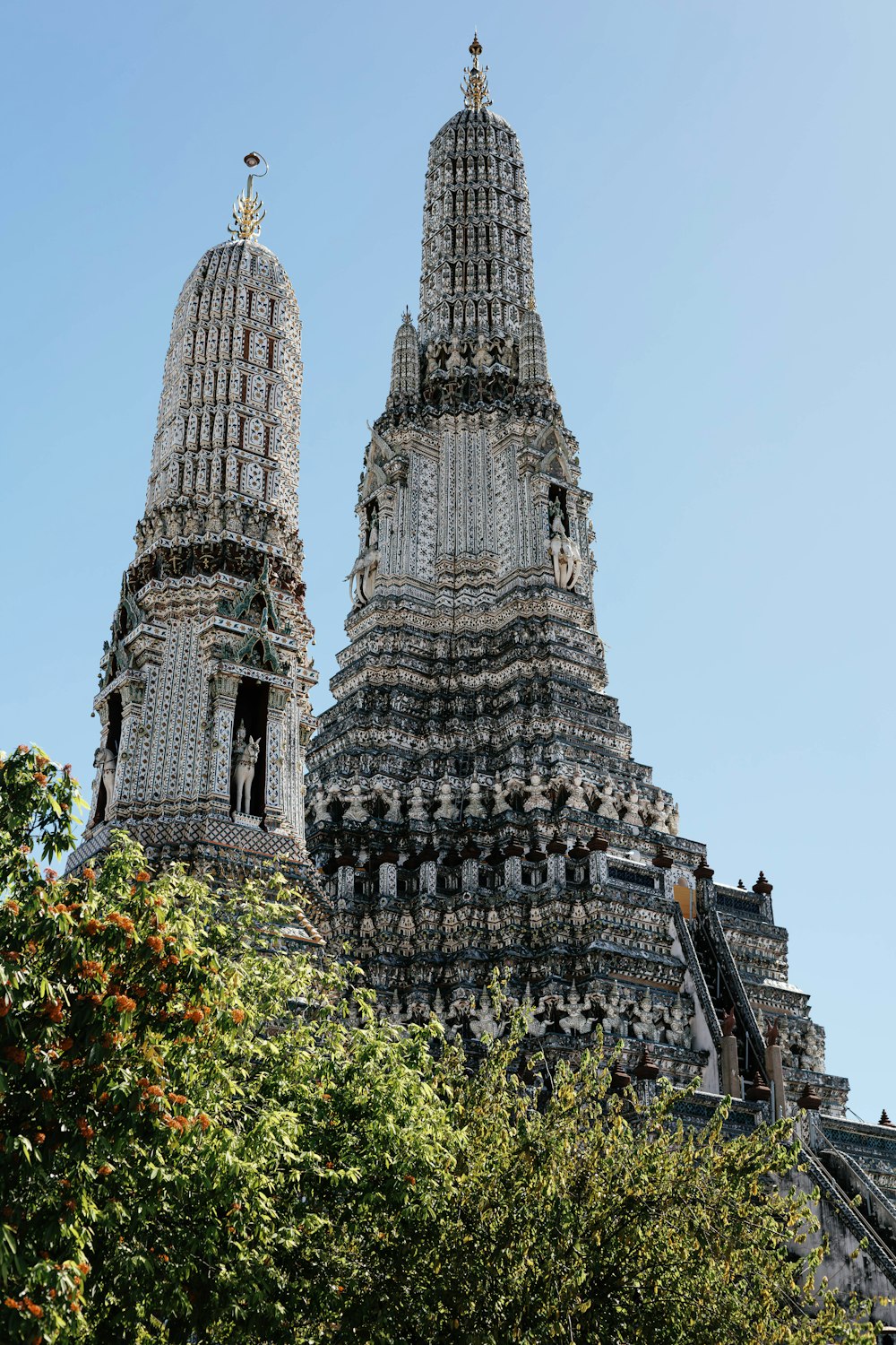 a very tall tower with a clock on it's side