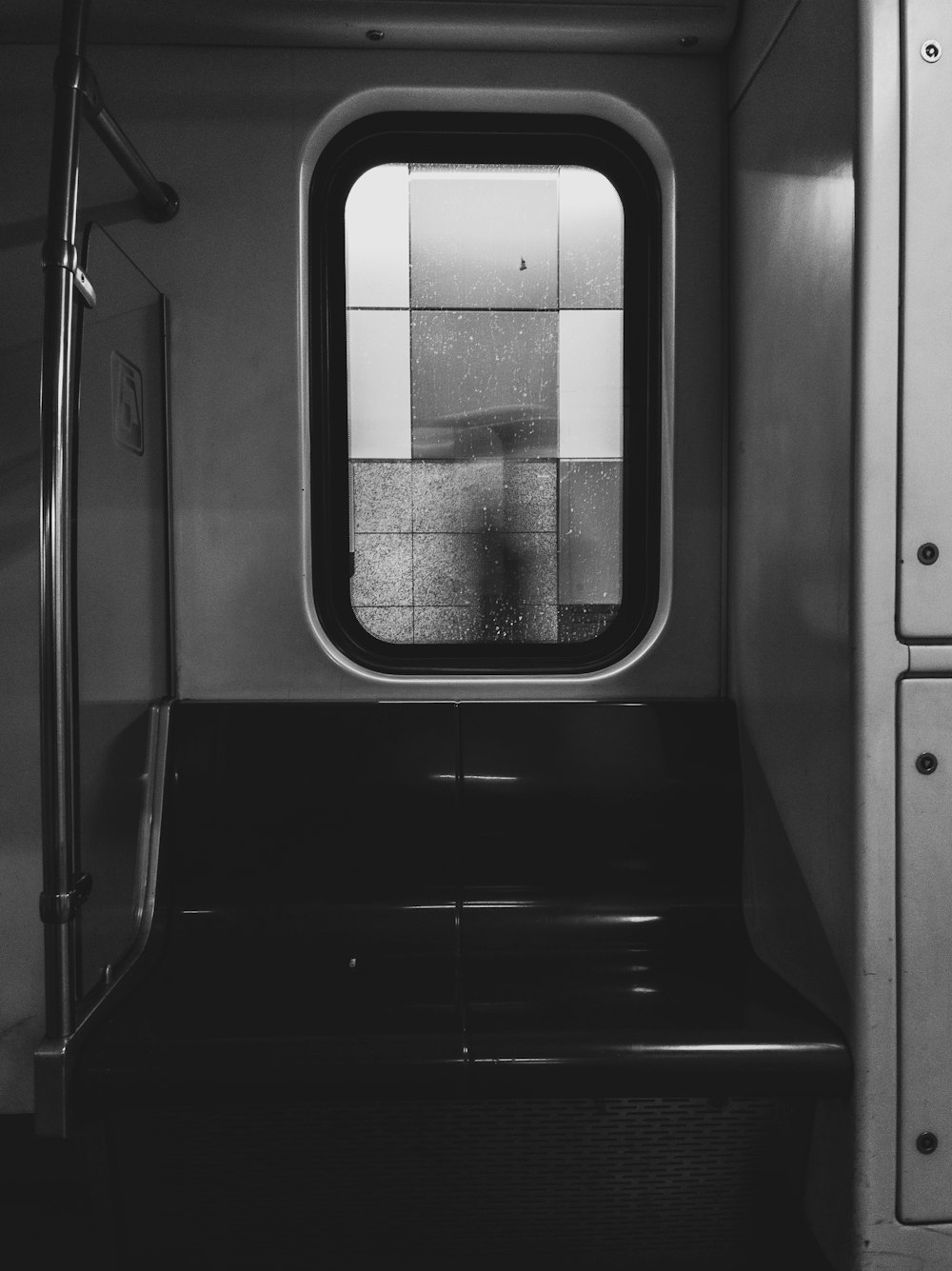 a black and white photo of a window on a train