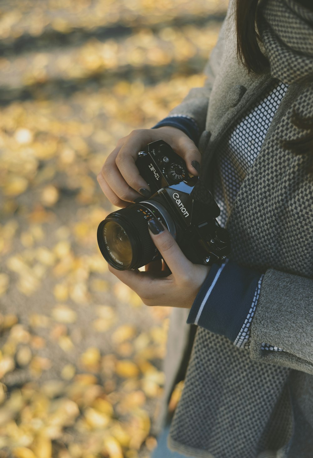 a woman holding a camera in her hands