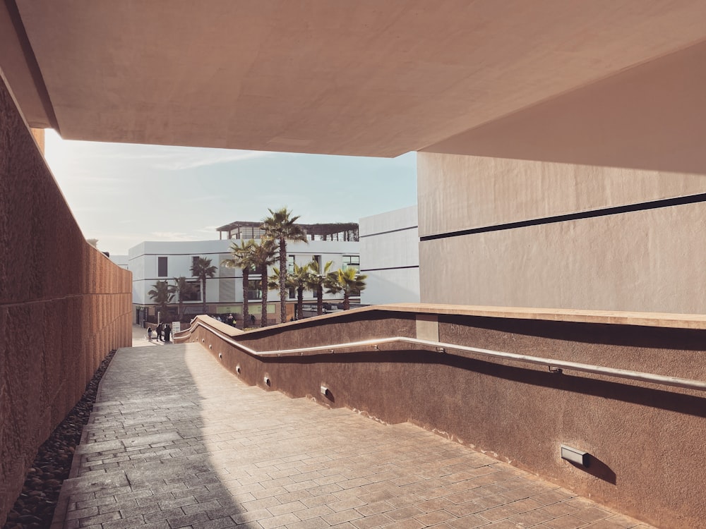 a person walking down a walkway next to a building