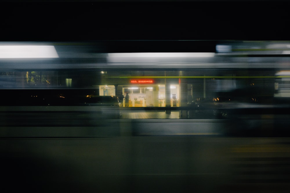a blurry photo of a train station at night