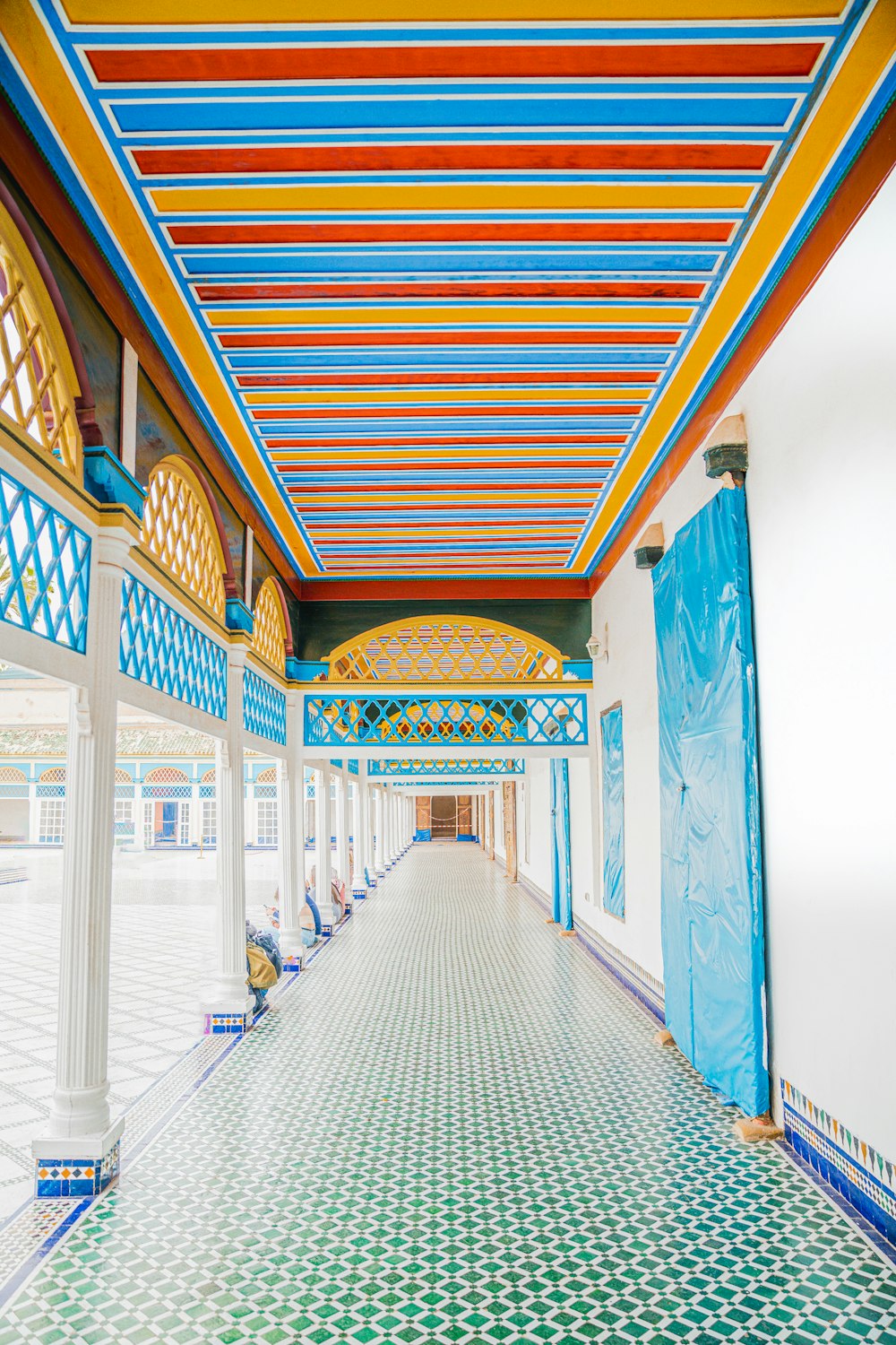 a hallway with a tiled floor and colorful ceiling