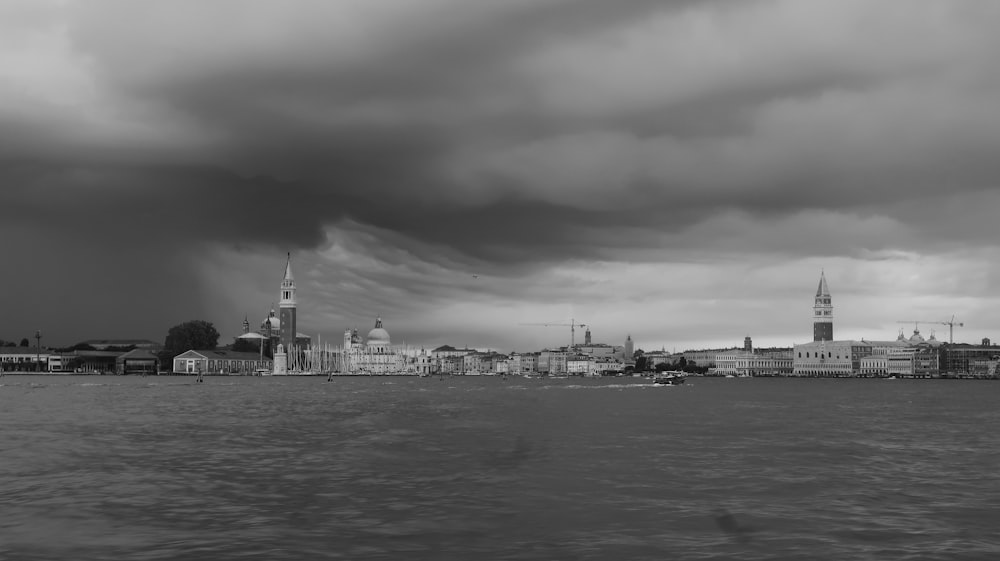 a black and white photo of a city on a cloudy day
